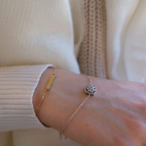 Stylish close-up shot of a wrist showcasing gold and silver bracelets, perfect for fashion and jewelry enthusiasts.