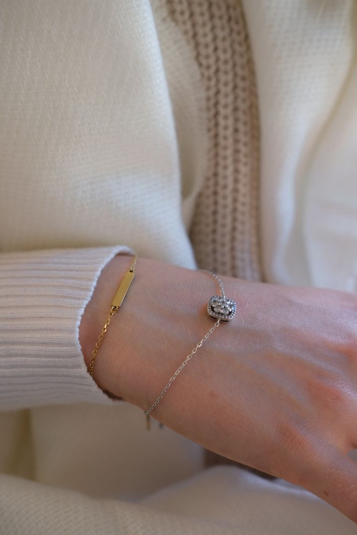 Stylish close-up shot of a wrist showcasing gold and silver bracelets, perfect for fashion and jewelry enthusiasts.